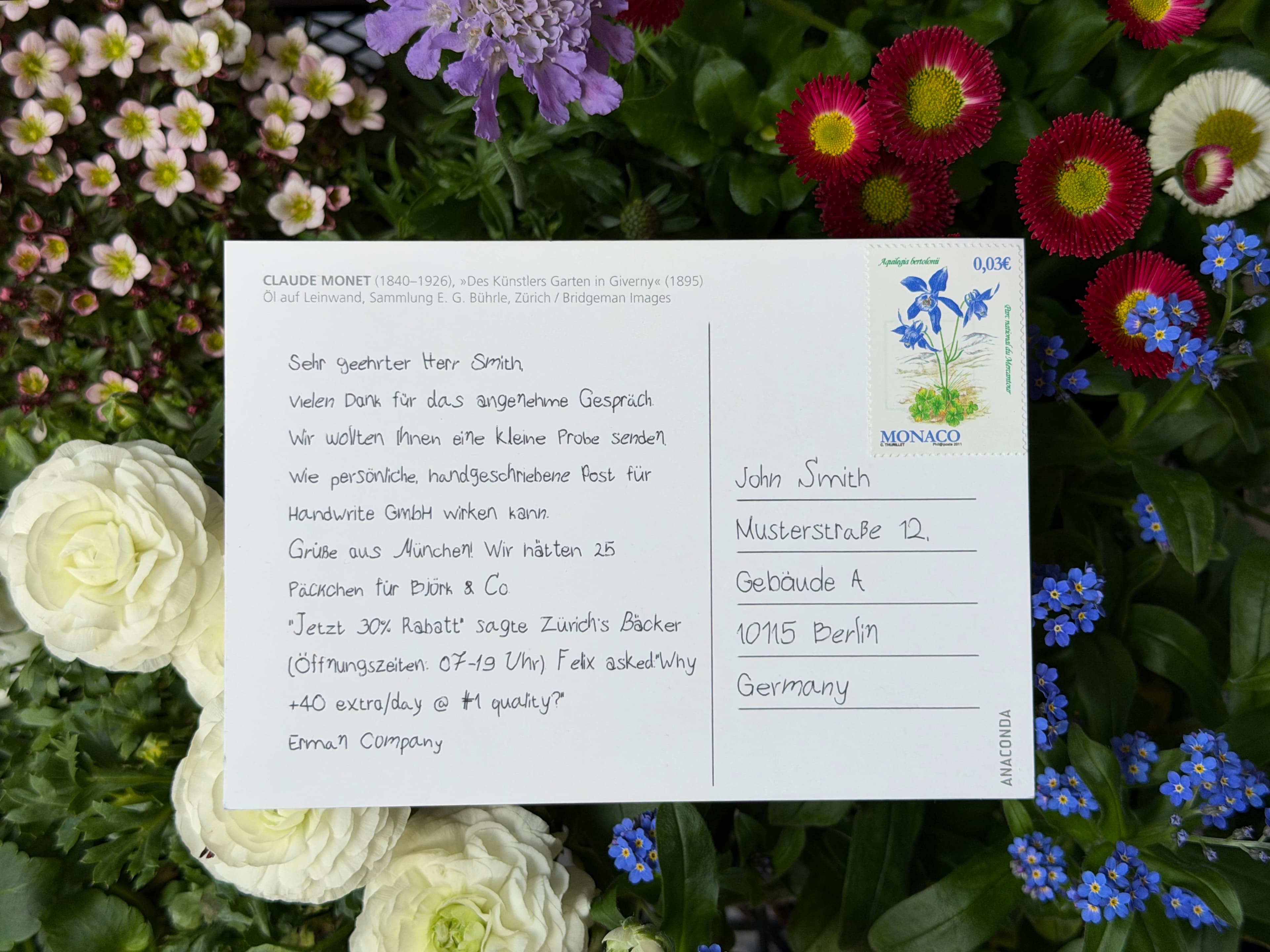 Handwritten postcard specimen photographed beside the pen plotter