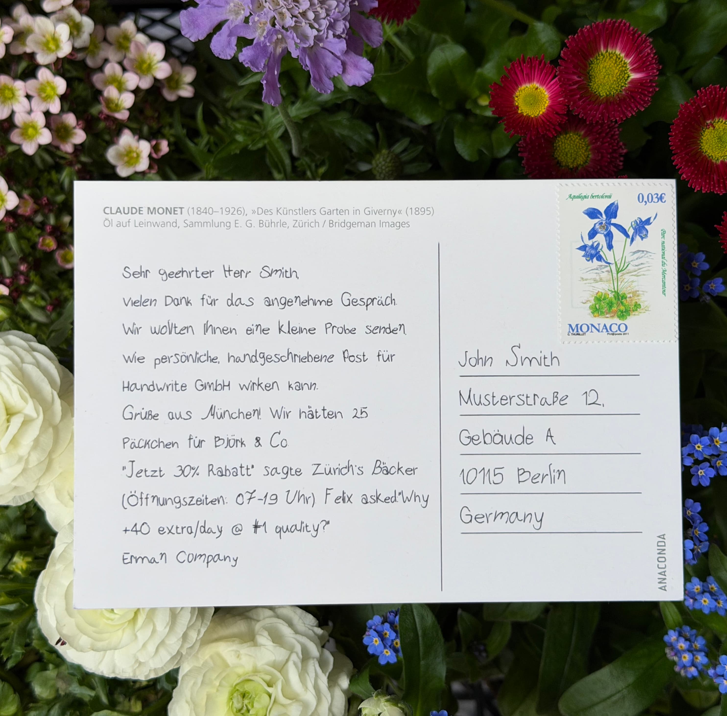 Finished handwritten postcard photographed beside the pen plotter